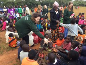 pupils giving out gifts donated by people in scotland to the mary martha rehabilitation and orphan care centre